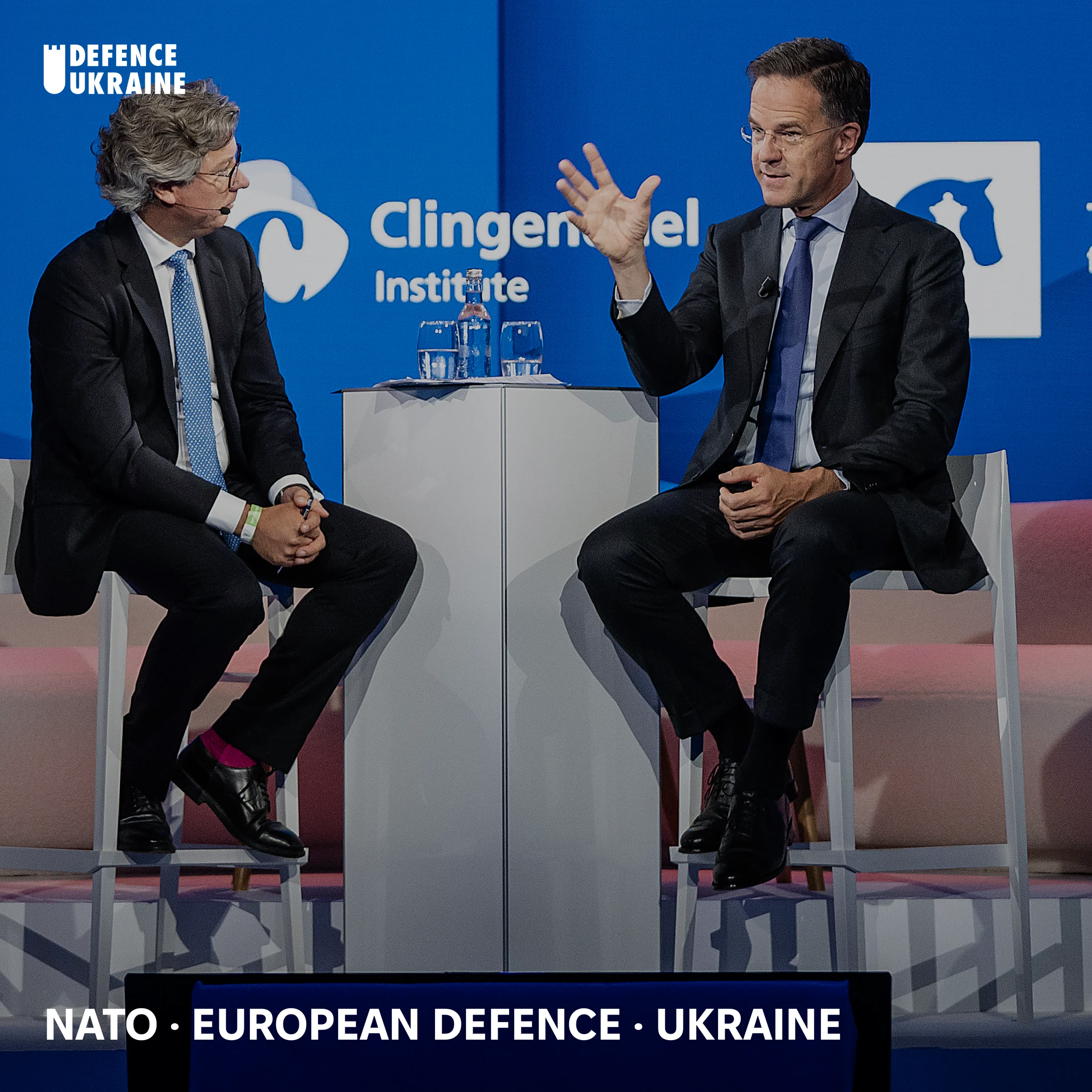 NATO Secretary General Mark Rutte at the NATO Public Forum, Hague Summit 2025, in a moderated conversation with Atlantische Commissie, Clingendael Institute, and Hague Centre for Strategic Studies branding visible.